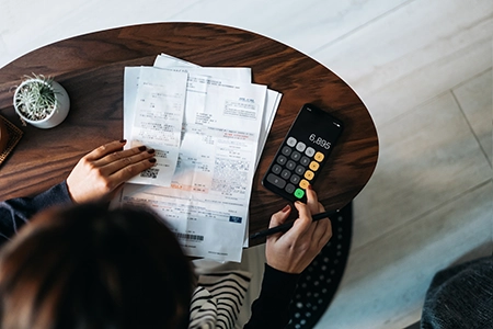woman with papers and calculator